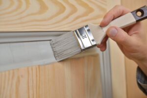 Painter working on doors